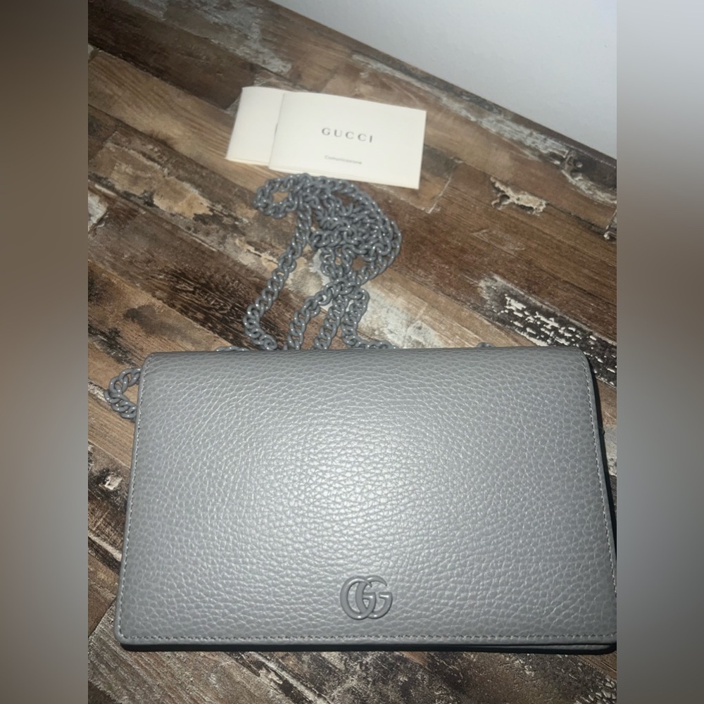 Gray Gucci handbag crossbody wallet on chain.